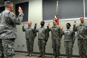 Five Louisiana National Guardsmen take the Oath of Enlistment, administered by Lt. Col Richard Douget, 773rd Military Police Battalion commander, during a retention event at Camp Minden, La., Dec. 5, 2015. The event allowed Soldiers who were nearing the end of their contracts to discuss their careers with leaders, ask questions, and resolve issues that may have prevented them from continuing to serve. (U.S. Army National Guard photo by Staff Sgt. Scott D. Longstreet)