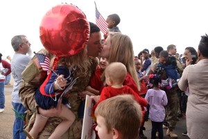 Staff Sgt. Chad Lawless of Swartz, La., kisses his wife, Angela and hugs his daughter, Lily, 4, sons Luke, 2, and Levi, 6-months. Lawless met Levi for the first time in person at the welcome-home event in Monroe, La., Dec. 24, 2015. More than 150 members of the Louisiana National Guard’s 1023rd Engineer Company, 528th Engineer Battalion just completed a 10-month deployment to Kuwait, with additional missions to Jordan, Iraq and Afghanistan. (U.S. Army National Guard photo by 1st Lt. Rebekah Malone)