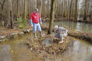 Louisiana National Guard Sgt. Aerrial Fredricks, a chemical, biological and radiological and nuclear specialist with Headquarters and Headquarters Company, 528th Engineer Battalion and Steven Evans, a construction controller with the U.S. Army Corps of Engineers inspect a sand boil in Newellton, La., Jan. 8, 2016. The LANG is conducting 24-hour levee patrols in the parishes of Concordia, East Carroll, Madison and Tensas to inspect for any leaks or seepage that has been caused by the winter river flooding. (U.S. Army National Guard photo by Sgt. Noshoba Davis)