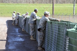 Soldiers with the Louisiana National Guard’s 769th Brigade Engineer Battalion, 256th Infantry Brigade Combat Team, secure HESCO bastion in efforts to build protective flood barriers in Krotz Springs, Louisiana, in support of Operation Winter River Flooding, Jan. 9, 2016. The Guardsmen worked in partnership with the community of Krotz Springs and the Department of Transportation and Development to protect the city from any flooding. (U.S. Army National Guard photo by Spc. Tarell J. Bilbo/Released)