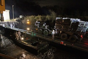 The Louisiana National Guard continues to work around the clock assisting local officials in the ferrying of equipment and construction of a levee of HESCO barriers on Avoca Island to protect Morgan City and the surrounding area from high river water, Jan. 9, 2016. The barrier will be used in the construction of a 2-mile long levee to prevent backwater flooding from reaching Morgan City and other towns in South Louisiana. (U.S. Army National Guard photos by Spc. Garrett L. Dipuma) 