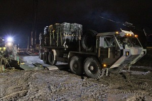 The Louisiana National Guard continues to work around the clock assisting local officials in the ferrying of equipment and construction of a levee of HESCO barriers on Avoca Island to protect Morgan City and the surrounding area from high river water, Jan. 9, 2016. The barrier will be used in the construction of a 2-mile long levee to prevent backwater flooding from reaching Morgan City and other towns in South Louisiana. (U.S. Army National Guard photos by Spc. Garrett L. Dipuma) 