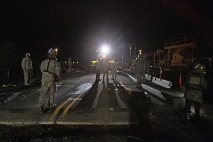 The Louisiana National Guard continues to work around the clock assisting local officials in the ferrying of equipment and construction of a levee of HESCO barriers on Avoca Island to protect Morgan City and the surrounding area from high river water, Jan. 9, 2016. The barrier will be used in the construction of a 2-mile long levee to prevent backwater flooding from reaching Morgan City and other towns in South Louisiana. (U.S. Army National Guard photos by Spc. Garrett L. Dipuma) 