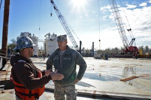 Curtis Middleton, an engineering technician with CB&I, briefs Louisiana National Guard Lt. Col. Rich Hanes, executive officer, 256th Infantry Brigade, on work to seal the Intracoastal Waterway from rising river levels near Morgan City, La., Jan. 11, 2016. The project will prevent backwater flooding from reaching Morgan City and other towns in south Louisiana. (U.S. Army National Guard photo by Spc. Joshua Barnett)
