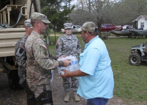 Sgt. David Breaud of Deville, La., with Headquarters and Headquarters Company 225th Engineer Brigade, assists the Grant Parish Sheriff's Office distribute water to local residents at Latt Lake in Grant Parish, La., March 13, 2016. (U.S. Army National Guard photo by Staff Sgt. Jerry Rushing)