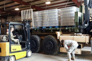 Louisiana National Guardsmen from the 1086th Transportation Company load and stack bottles of water to be delivered and distributed to affected parishes during emergency flood operations in Bunkie, Louisiana, March 13, 2016. The LANG has been assisting local officials in the flood fight since March 9, 2016. (U.S. Army National Guard photo by Sgt. 1st Class Natalie Wall)
