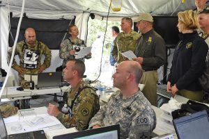 Louisiana National Guard Lt. Col. Michelle Story, 61st Troop Command operations officer, briefs Louisiana Governor John Bel Edwards (center), Maj. Gen. Glenn H. Curtis, adjutant general of the Louisiana National Guard (left) and Dr. Rebekah Gee, La. Department of Health and Hospitals secretary, (right) on the current operation of the Louisiana National Guard’s Chemical, Biological, Radiological, Nuclear and High Yield Explosive (CBRNE) Enhanced Response Force Package (CERFP) during Vigilant Guard 2016, at the Joint Emergency Services Training Center in Zachary, La., April 15, 2016. (U.S. Air National Guard photo by Master Sgt. Toby Valadie)