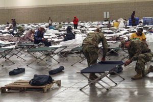 Soldiers from the Louisiana National Guard's 2228th Military Police Company headquarted in Alexandria setting up cots inside of the Baton Rouge River Center August 15, 2016 after major flooding pushed them from their homes over the last several days.. Guardsman here are also assisting Louisiana State Police with security. (U.S. Army National Guard photo by Spc. Garrett L. Dipuma/RELEASED)