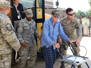 Members of the 159th Fighter Wing, Louisiana Air National Guard transport flood evacuee and World War II veteran, Mr. Willis Woods from the Celtic Media Centre shelter to a special needs facility near the Louisiana State University campus on August 15, 2016. The Louisiana National Guard mobilized more than 1,000 guardsmen in response to heavy flash flooding that occurred in south Louisiana on August 13, 2006. (U.S. Air National Guard Photo by Master Sgt. Dan Farrell)