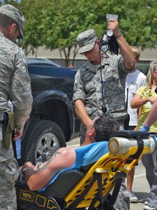 TSgt Roger Butterfield with the 259 Air Traffic Control Squadron, Louisiana Air National Guard, utilizes his skills as a full-time firefighter with the Lake Charles Fire Department to assist a flood evacuee that suffering from heat exhaustion at a shelter located at the Celtic Media Centre in Baton Rouge, La. on August 15, 2016. The Louisiana National Guard mobilized more than 1,000 guardsmen in response to heavy flash flooding that occurred in south Louisiana on August 13, 2006. (U.S. Air National Guard Photo by Master Sgt. Dan Farrell)