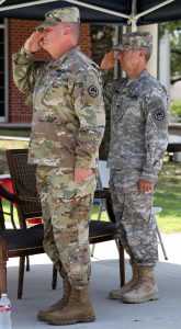 Maj. Gen. Glenn H. Curtis, the adjutant general of the Louisiana National Guard, and retired Col. Douglas Mouton, salute the flag one last time together during the playing of the National Anthem at Mouton's retirement ceremony at Jackson Barracks in New Orleans, Louisiana, Aug. 6, 2016. Mouton served 32 years in the Louisiana Army National Guard. (Louisiana National Guard photo by Sgt. Renee Seruntine)