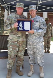 Maj. Gen. Glenn H. Curtis, the adjutant general of the Louisiana National Guard, presents retired Col. Douglas Mouton with the Minuteman Award during Mouton's retirement ceremony at Jackson Barracks in New Orleans, Louisiana, Aug. 6, 2016. Mouton has received several awards and accolades during his 32 years of service in the Louisiana Army National Guard. (Louisiana National Guard photo by Sgt. Renee Seruntine)