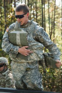 U.S. Army Pfc. Alec Wheeler, an Explosive Ordnance Disposal soldier, assigned to the 797th Ordnance Company (EOD), 79th Ordnance Battalion (EOD), 71st Ordnance Group, from Fort Hood, Texas, straps on his improved outer tactical vest in the safe zone on Camp Minden in Minden, Louisiana, Nov. 1, 2016. Wheeler was preparing to conduct a controlled burn of a magazine containing Clean Burning Ignitor and M6 propellant that had become destabilized. (U.S. Army Photo by Pfc. Cole Erickson)