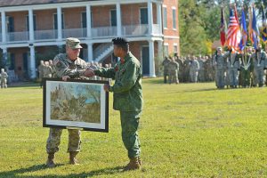 Maj. Gen. Glenn H. Curtis, adjutant general of the Louisiana National Guard presents Brig. Gen. David Jones, commander of the Belize Defence Force, with a commemorative print to celebrate the 20th anniversary of the Stare Partnership Program between Louisiana and Belize on Nov. 4, 2016, at Jackson Barracks, New Orleans, La. The print highlights just a few of the many training opportunities conducted over the past 20 years – “Shoulder to Shoulder Together We Protect What Matters.” (U.S. Air National Guard photo by MSgt Toby M. Valadie)