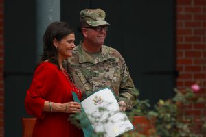 Brig. Gen. Lee Hopkins, the La. National Guard Director of Joint Staff, presents Denise Champagne with a certificate of appreciation during her husband, Col. Brian P. Champagne's, retirement ceremony at Jackson Barracks in New Orleans Nov. 5, 2016. (U.S. Army National Guard photo by Pfc. Cody Wolfgang Kellum)
