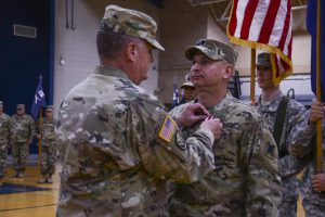 Maj. Gen. Glenn H. Curtis, the adjutant general of the Louisiana National Guard, presents outgoing commander Lt. Col. William Haygood, a Gonzales, La., resident with the Meritorious Service Award during an official change of command ceremony at Erath High School in Erath, La., Nov. 6, 2016. Haygood handed over command to Lt. Col. Scott Desormeaux, an Abbeville, La., resident, and is currently the strategic planner for the Louisiana Military Department. (U.S. Army National Guard photo by Sgt. Noshoba Davis)