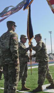 Lt. Col. William Rachal, a Merryville, La., native and the incoming commander of the Louisiana National Guard's 256th Infantry Brigade Combat Team, receives the organizational colors from Maj. Gen. Glenn H. Curtis, adjutant general of the LANG, during an official change of command ceremony at St. Thomas More High School in Lafayette, La., Nov. 6, 2016. Rachal is currently the chief of staff for the Governor's Office of Homeland Security and Emergency Preparedness. (U.S. Army National Guard photo by Staff Sgt. Gregory Stevens)