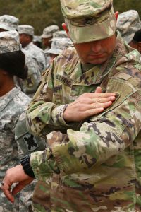 Alabama National Guardsman Staff Sgt. Mark Williams, a resident of Luverne, Ala., and supply sgt. of the 31st Forward Support Co., 1st Battalion, 173rd Infantry Regiment, 256th Infantry Brigade, secures his new unit patch to to his uniform during an official patching ceremony in Enterprise, Ala., Jan. 3, 2016. (U.S. Army National Guard photo by Spc. Garrett L. Dipuma)