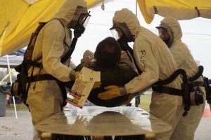 Soldiers of the Louisiana National Guard's Chemical, Biological, Radiological, Nuclear and High Yield Explosive Enhanced Response Force Package move a victim to the beginning of a decontamination tent during a training held at the Joint Emergency Services Training Center in Zachary. The CERFP conducts this type of training several times a year to maintain readiness in case they need to respond to an emergency. (U.S. Army National Guard photo by Spc. Garrett L. Dipuma)