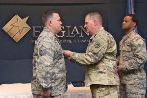 Major Gen. Glenn H. Curtis, adjutant general of the Louisiana National Guard, awards Master Sgt. Trent Taylor, 259th Air Traffic Control Squadron, Louisiana Air National Guard, the Air Force Commendation Medal during an award ceremony at the England Air Park Terminal in Alexandria, Louisiana, April 15, 2018. Airmen from the 259th received three Bronze Star, 11 Air Force Commendation and two Air Force Achievement medals during the ceremony for exemplary service during their deployment to Iraq in support of Operation Inherent Resolve. (U.S. Air National Guard photo by Senior Airman Cindy Au)