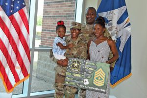 Sgt. Maj. Demetria Faircloth-Ivory and her family stand together after her official promotion ceremony at Camp Beauregard in Pineville, Louisiana, July 19, 2019. (U.S. Army National Guard photo by Staff Sgt. Garrett L. Dipuma)