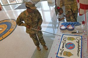 Sgt. Maj. Demetria Faircloth-Ivory cuts a cake with a non-commissioned officer ceremonial sword at her official promotion ceremony at Camp Beauregard in Pineville, Louisiana, July 19, 2019. (U.S. Army National Guard photo by Staff Sgt. Garrett L. Dipuma)