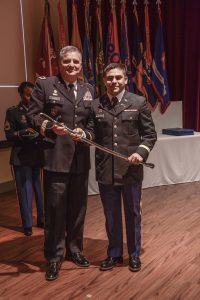 Maj. Gen. Glenn H. Curtis, adjutant general of the Louisiana National Guard, presents Officer Candidate School honor graduate 2nd Lt. Benjamin Berroteran, of Shreveport, with the Adjutant General's Award during the Officer Candidate School graduation ceremony at Camp Beauregard in Pineville, Louisiana, Aug. 10, 2019. Berroteran was one of 12 officers commissioned during the ceremony and will be an officer with B Troop, 2nd Squadron, 108th Cavalry Regiment, 256th Infantry Brigade Combat Team. (U.S. Army National Guard photo by Staff Sgt. Noshoba Davis)