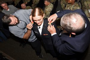 Officer Candidate School graduate 2nd Lt. Natilyn Smith, of Port Sulphur, Louisiana, is pinned with her second lieutenant bars by family members during an official ceremony at Camp Beauregard in Pineville, Louisiana, Aug. 10, 2019. Smith was one of 12 new officers commissioned during the ceremony. (U.S. Army National Guard photo by Staff Sgt. Garrett L. Dipuma)
