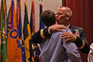 Brig. Gen. Damian “Keith” Waddell kisses his son on the cheek during his promotion ceremony at Camp Beauregard in Pineville, Louisiana, Aug. 10, 2019. Outside of the Louisiana National Guard, Waddell is an assistant principal at Westlake High School, and has worked in the Louisiana Education Department for the last 24 years. (U.S. Army National Guard photo by Staff Sgt. Garrett L. Dipuma)