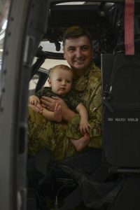 Louisiana National Guard Chief Warrant Officer 2 Paul Glankler, of Alexandria, Louisiana, with 2nd Battalion, 238th Aviation Regiment, spends time with his son, Gus, after a deployment ceremony at the Army Aviation Support Facility #2 at Esler Field in Pineville, Louisiana, Sept. 6, 2019. The 2-238th is sending more than 50 Guardsmen, including two father-son teams and one married couple, to Afghanistan. (U.S. Army National Guard photo by Staff Sgt. Noshoba Davis)