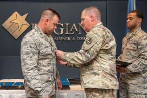 Maj. Gen. Glenn H. Curtis, adjutant general of the Louisiana National Guard, awards Capt. Alex Sattler, 259th Air Traffic Control Squadron, Louisiana Air National Guard, the Bronze Star Medal during the 259th award ceremony at the England Air Park Terminal in Alexandria, Louisiana, April 15, 2018. Sattler was one of 16 Airmen from the LAANG honored for their deployment to Iraq in support of Operation Inherent Resolve. (U.S. Air National Guard photo by Senior Airman Cindy Au)