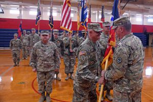 Louisiana National Guardsman Lt. Col. Scott Desormeaux receives the 256th Infantry Brigade Combat Team colors from Maj. Gen. Glenn H. Curtis, adjutant general of the LANG, symbolizing his assumption of command from Col. William Rachal during an official ceremony at Comeaux High School in Lafayette, Louisiana, Nov. 2, 2019. During the ceremony, several battalions under the Tiger Brigade also held changes of command. (U.S. Army National Guard photo by Staff Sgt. Garrett L. Dipuma)