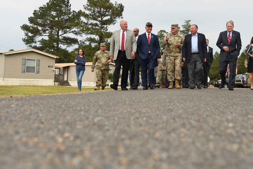 Louisiana Gov. John Bel Edwards (second from left) walks with Maj. Gen. Glenn H. Curtis (center), adjutant general of the Louisiana National Guard, at Camp Beauregard in Pineville, Louisiana, Nov. 11, 2019. Edwards pledged $10 million to a project that will replace the mobile homes that were brought in to house displaced families after Katrina with permanent housing. (U.S. Army National Guard photo by Staff Sgt. Garrett L. Dipuma)