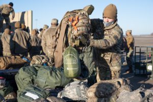 Louisiana National Guard soldiers and airmen from throughout the state prep their gear and board planes in order to assist the District of Columbia National Guard to ensure a safe and secure presidential inauguration at the Alexandria Airport in Alexandria, Louisiana, Jan. 16, 2021. The National Guard Bureau requested support from guardsmen from across the states and territories to provide crowd management; traffic control in and around the Capitol, National Mall and White House; as well as communications, logistical, medical, and public affairs support. (U.S. Army National Guard photo by Staff Sgt. Josiah Pugh)