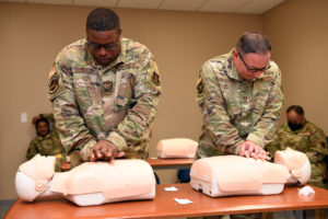 Capt. Pierre Paul Castaing Jr., 159th Operations Group, and Staff Sgt. Tyron Kennedy, 159th Communications Flight, practice chest compressions during a Red Cross CPR class during the 159 Fighter Wing’s annual training in Savannah, Ga., June 7, 2021. Airmen complete annual training requirements to maintain mission readiness as hurricane season approaches. (U.S. Air National Guard photo by Senior Airman Dane St. Pe)