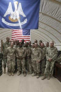 Brig. Gen. Keith Waddell, the adjutant general of the Louisiana National Guard, awards his challenge coin to Soldiers of B Company, 136th Expeditionary Signal Battalion, who have executed their jobs with a dedication and professionalism above their peers. The 136th is currently deployed in support of U.S. Central Command. (U.S. Army National Guard photo by Staff Sgt. Noshoba Davis)