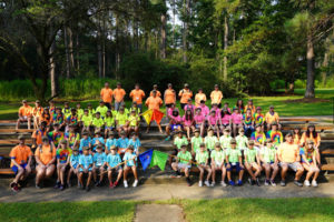 Campers and volunteers take their camp photo during the Louisiana National Guard’s annual military kids’ Camp Pelican Pride event at the Feliciana Retreat and Conference Center in Norwood, La., Aug. 5, 2021. Children and siblings of Louisiana soldiers and airmen spent four days each attending the fun, military-style summer camp at the center going through different tracks, such as marching, rock wall climbing, fishing and paddling, and resilience and disaster preparedness training. (U.S. Army National Guard photo by Sgt. 1st Class Denis B. Ricou)