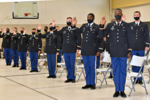 Graduates of the Louisiana Army National Guard's Officer Candidate School from Class 60 and 62B recite the Oath of Office before being pinned with their second lieutenant bars by family members at Camp Beauregard in Pineville, Louisiana, Aug. 8, 2021. Since the first class graduated in August 1961, approximately 1,791 second lieutenants have been commissioned through Louisiana's program. (U.S. Army National Guard photo by Staff Sgt. Thea James)