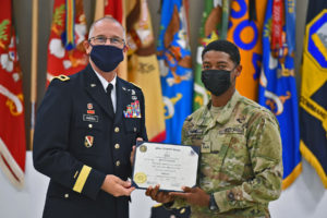 Maj. Gen. Keith Waddell, adjutant general of the Louisiana National Guard, presents 2nd Lt. Renon M. Baizar of Belize with his Officer Candidate School’s graduation diploma at Camp Beauregard in Pineville, Louisiana, Aug. 8, 2021. For 25 years, Louisiana and Belize have been state partners participating in the state partnership program. (U.S. Army National Guard photo by Staff Sgt. Thea James)