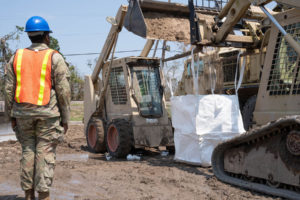 Louisiana National Guardsmen assigned to the 225th Engineer Brigade work to fill super sacks that assist in flooding blockade, Des Allemands, La., Sept. 1, 2021. (U.S. Army National Guard photo by Staff Sgt. Josiah Pugh)