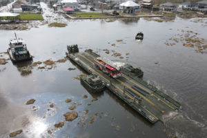Louisiana National Guardsmen with the 2225th Multi-Role Bridge Company ferry emergency responders and equipment from Lafitte to Barataria to assist locals with recovery efforts, Jean Lafitte, La., Sept. 4, 2021. The only bridge to Barataria was damaged during Hurricane Ida and was rendered inoperable. (U.S. Army National Guard photo by 1st Lt. Steven McCoppin)
