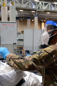 Louisiana National Guardsman Sgt. Kevin Alexander from Breaux Bridge, Louisiana, with the 2nd Battalion, 156th Infantry Regiment, administers a rapid COVID-19 test for an incoming patient at the temporary medical facility following Hurricane Ida at the New Orleans Ernest N. Morial Convention Center, Sept. 6, 2021. (U.S. Army National Guard photo by Staff Sgt. David Kirtland)