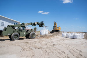 Louisiana National Guardsmen assigned to the 225th Engineer Brigade emplace 3-by-3 foot sacks filled with up to 4,000 pounds of sand each along twelve levee breaches, Grand Isle, Sept 24, 2021. Tidal surge from Hurricane Ida damaged the island’s levee leading to massive flooding. (U.S. Army National Guard photo by Staff Sgt. Josiah Pugh)