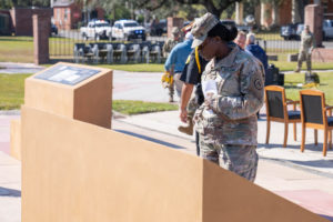 Attendees view historical markers following a Louisiana National Guard dedication ceremony for a memorial greenspace to honor the Native Americans, soldiers, civilians and enslaved people who lived, served and died at Jackson Barracks, New Orleans, Nov. 19, 2021. The greenspace is the result of a 2009 agreement among various state and federal agencies to include various Native American tribes, the Federal Emergency Management Agency, the Advisory Council on Historic Preservation, the Louisiana State Historic Preservation Office, the State of Louisiana, the Division of Administration, Facility Planning and Control, and the Louisiana Military Department. (U.S. Army National Guard photo by Staff Sgt. Josiah Pugh)