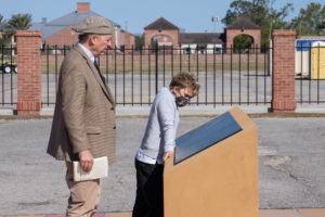 Attendees view historical markers following a Louisiana National Guard dedication ceremony for a memorial greenspace to honor the Native Americans, soldiers, civilians and enslaved people who lived, served and died at Jackson Barracks, New Orleans, Nov. 19, 2021. The greenspace is the result of a 2009 agreement among various state and federal agencies to include various Native American tribes, the Federal Emergency Management Agency, the Advisory Council on Historic Preservation, the Louisiana State Historic Preservation Office, the State of Louisiana, the Division of Administration, Facility Planning and Control, and the Louisiana Military Department. (U.S. Army National Guard photo by Staff Sgt. Josiah Pugh)